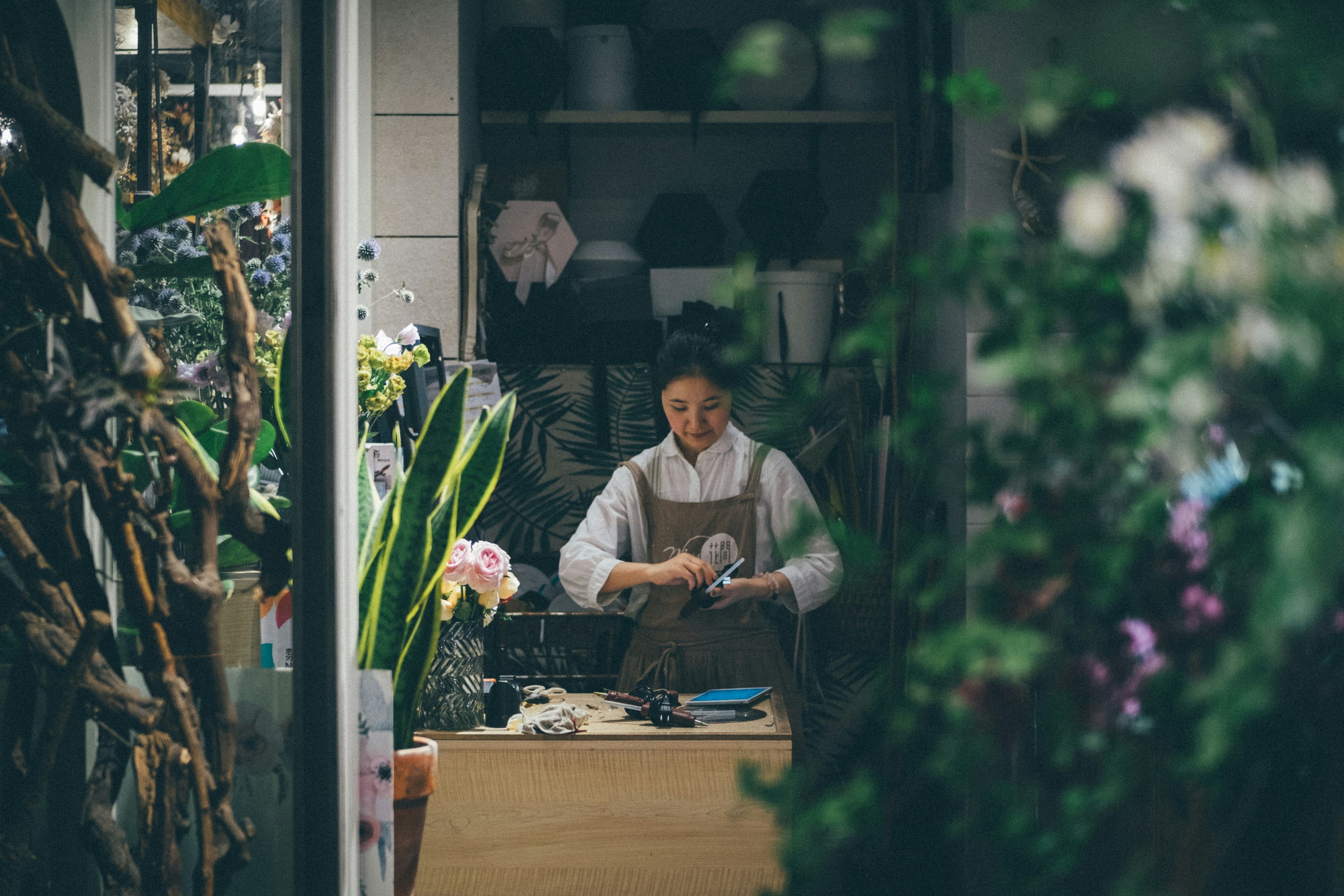 Small business owner working quietly in her flower shop